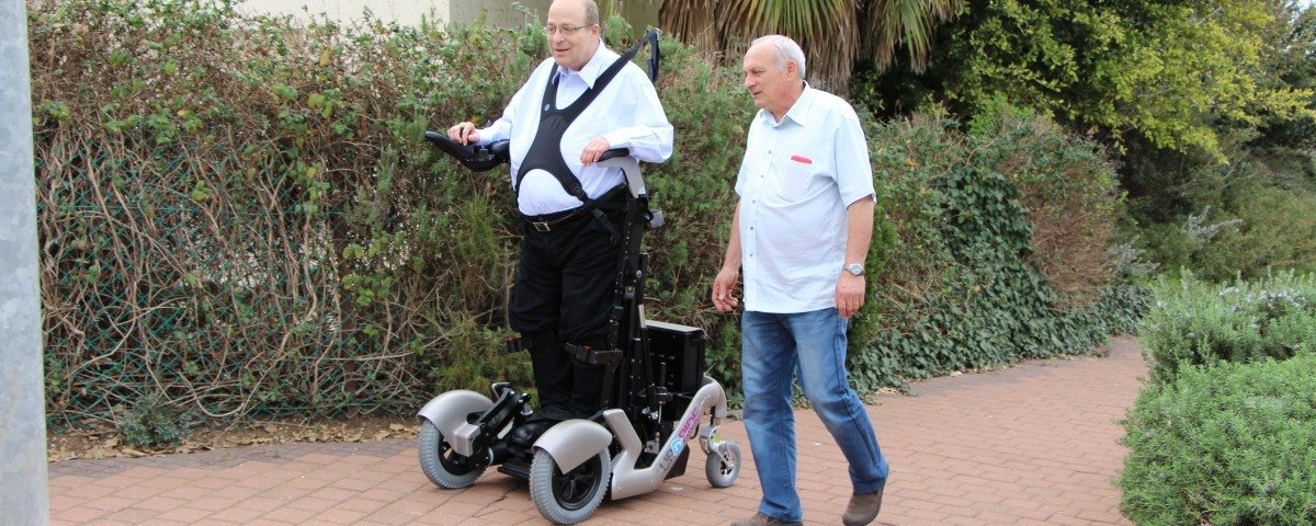Dr Amit Goffer goes utside standing up for first time using Israeli invention upright wheelchair