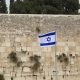 israel flag by the western wall to convey israel's aspiration to build the next holy temple