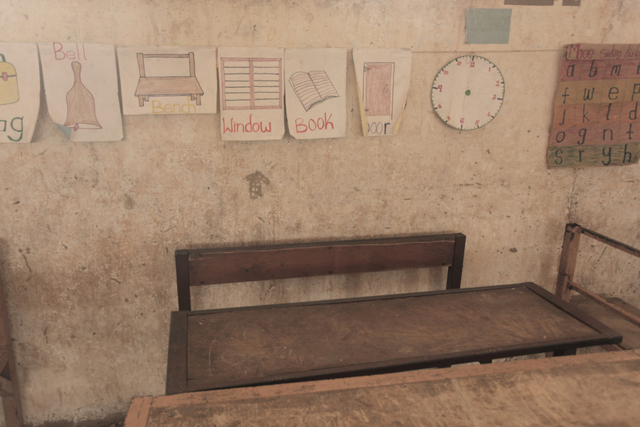 an elementary class room showing drawings of objects for children to read to show that in many plces in the world an elementry education is hard to achieve 