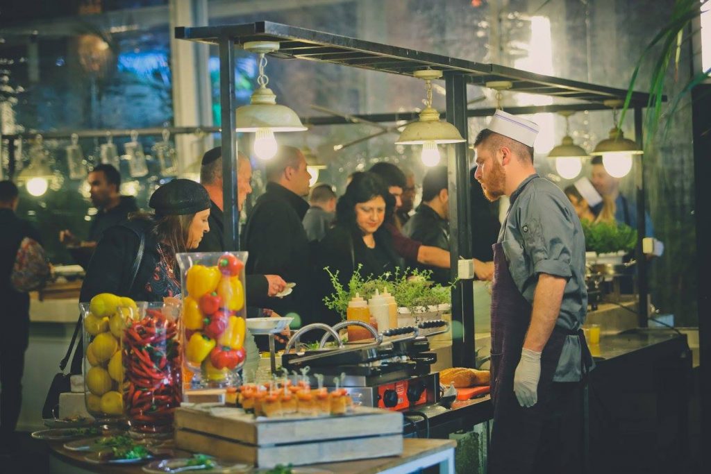 wedding guests taking food at a boufet at the reception in an Israeli wedding in israel