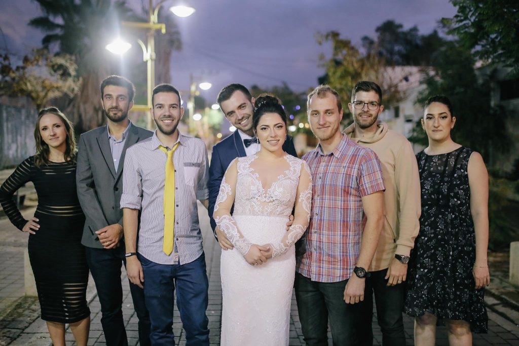 israeli friends with groom and bride taking a frontal picture before the ceremony in israel 
