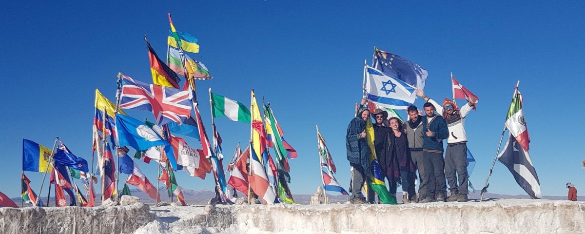 israeli group in the salt flats of bolivia holding israel flag